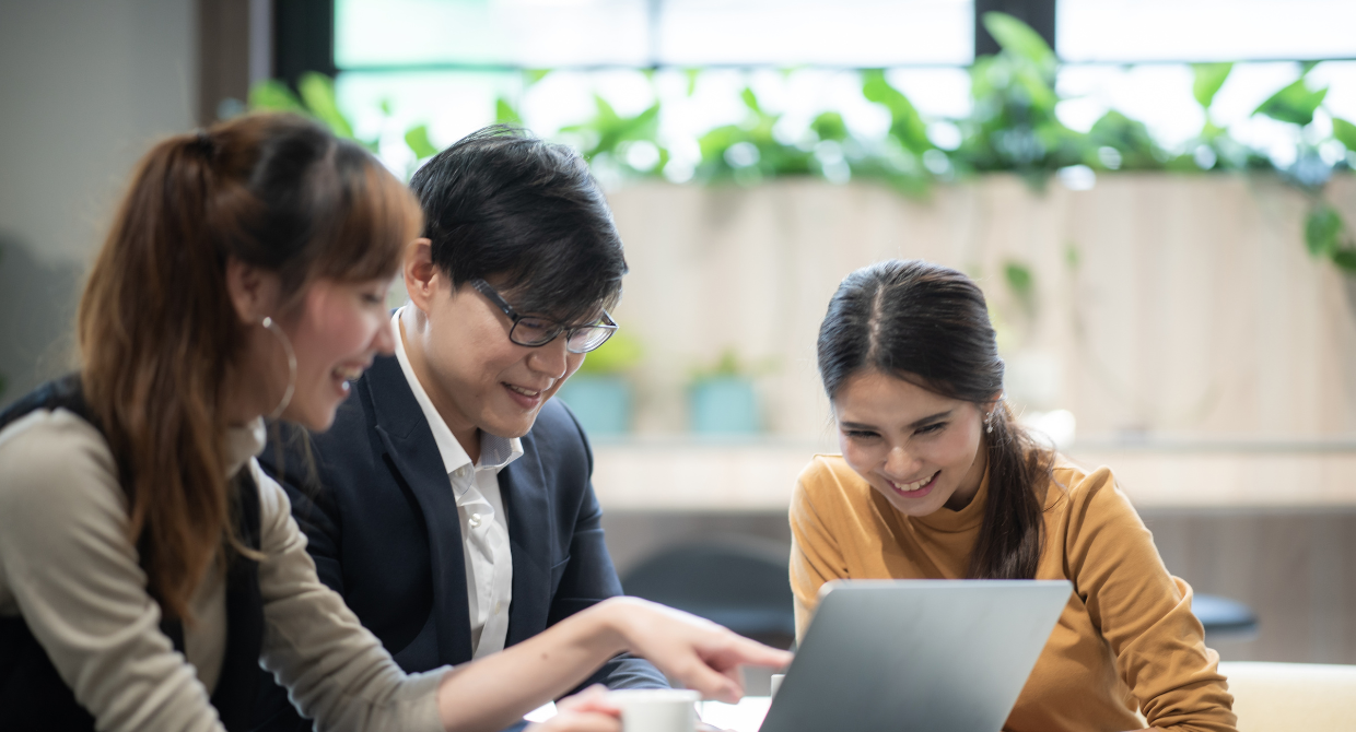 Colleagues collaborating looking at a laptop